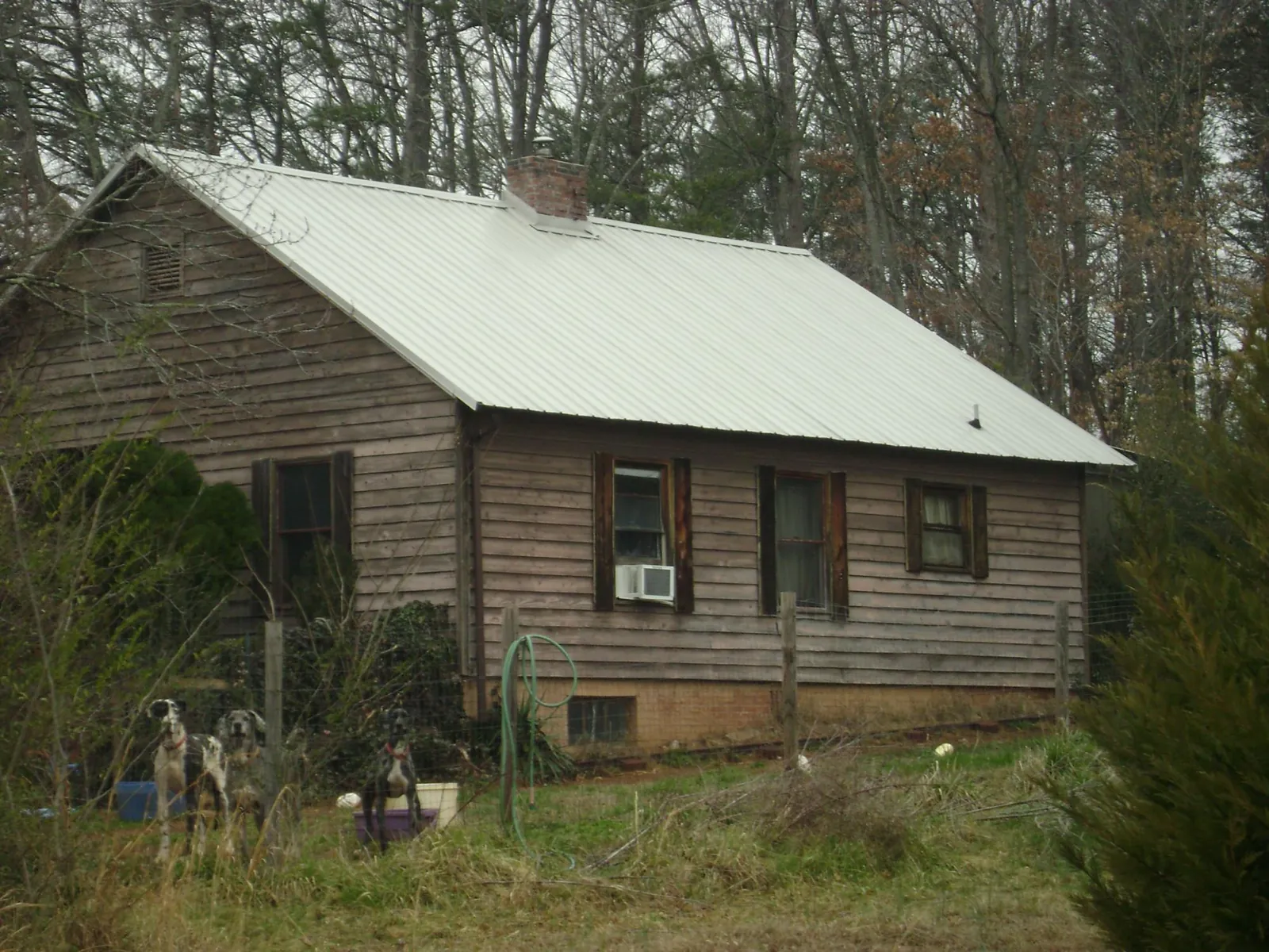 White metal roof on an old wood sided farmhouse, from a Metal Roof Installation job in Cleveland